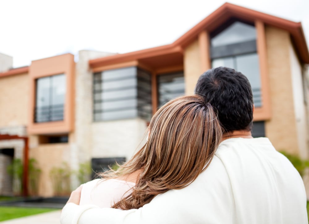 Loving couple looking at their dream house Loving couple looking at their dream house